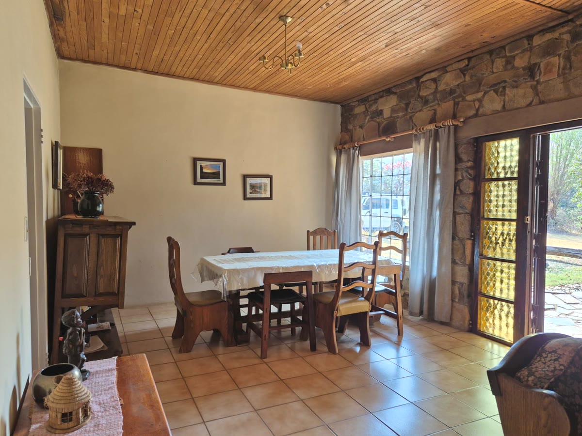 Dining room with a wooden table under a timber ceiling